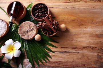 Beautiful spa setting on palm leaf on wooden table