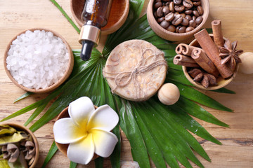 Beautiful spa setting on palm leaf on wooden table