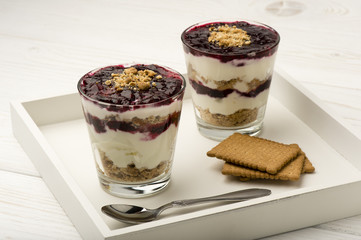 Healthy dessert with natural yogurt, full grain biscuits and black currant jam.
