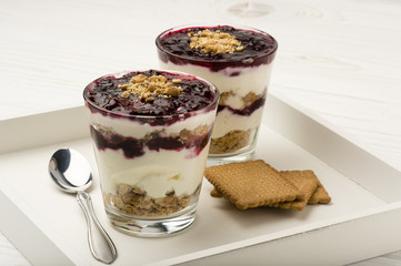 Healthy dessert with natural yogurt, full grain biscuits and black currant jam.