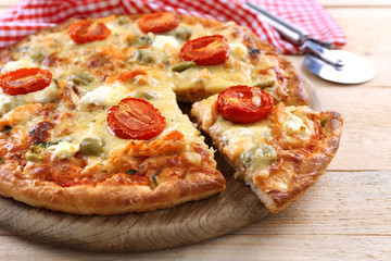 Delicious tasty pizza with cut slice, closeup