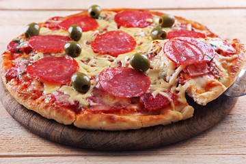 Delicious tasty pizza with cut slice, closeup