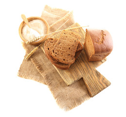 Sliced bread with ears and flour on napkin isolated on white
