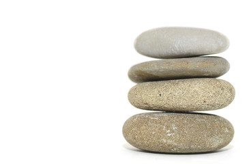 Fototapeta na wymiar Four stacked spa stones on a white background.