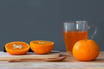 orange with orange juice in glass
