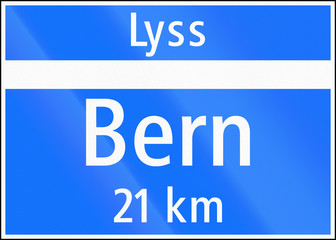 Road sign used in Switzerland - End of town (with distance to other town) on major road