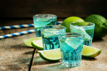 Blue cocktail with soda and lime, selective focus