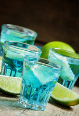 Blue cocktail with soda and lime, selective focus