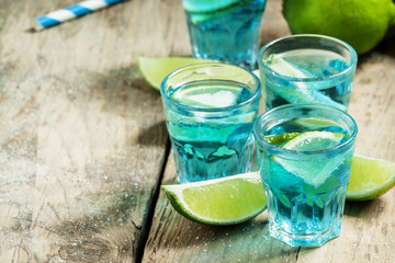 Blue cocktail with soda and lime, selective focus