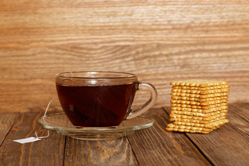 Cup of tea and cookies on wooden table