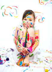 Obraz na płótnie Canvas Cute girl playing with paints