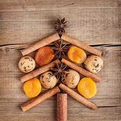 Christmas card with natural decorations on wooden background