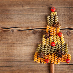 Christmas card with natural decorations on wooden background