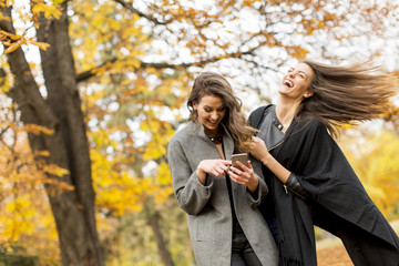 Fototapeta premium Pretty young women in the autumn park