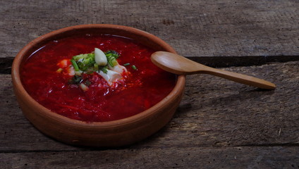 Russion traditional borsh on wooden table closeup