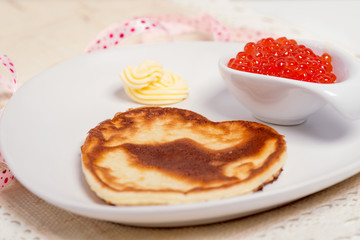 Pancake with salmon caviar and butter for breakfast