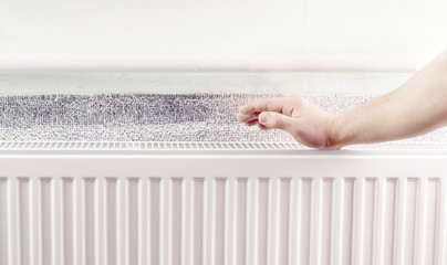 Warming hands near the aluminum radiator