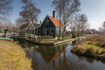 Fototapeta na wymiar Traditional Dutch old wooden windmill in Zaanse Schans