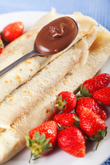 Pancakes with chocolate and strawberries