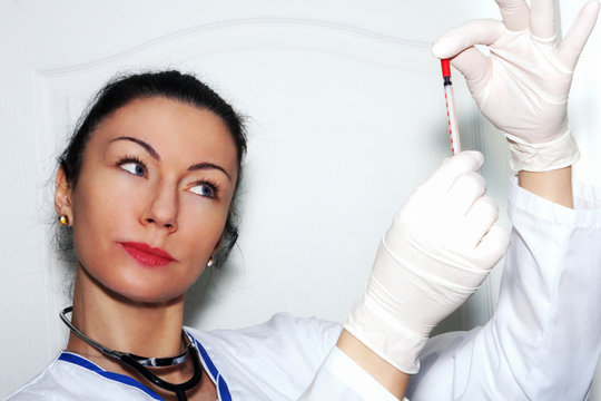 Female doctor checking the syringe