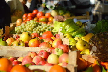Fresh fruits and vegetables at market in boxes