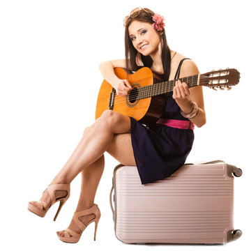Music lover, summer girl with guitar and suitcase