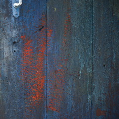 texture of old wooden planks with cracked and smeared paint