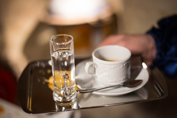 Waiter serving coffee at the restorant