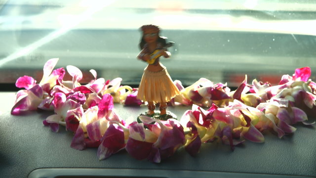 Hawaii Travel Car - Hula Doll Dancing On Dashboard And Lei During Road Trip