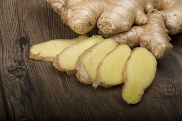 Ginger root sliced on the wooden table