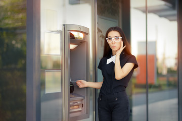 Stressed Woman with credit card at ATM