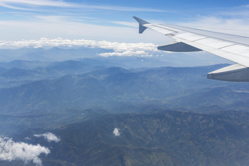 Fototapeta na wymiar Aerial view of Andean mountains and airplane wing, Colombia