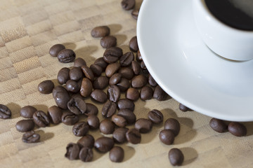 Coffee beans and espresso served on a white cup