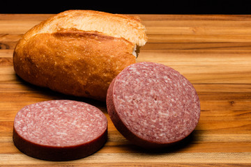 Torn Italian Bread With Two Chunks of Salami