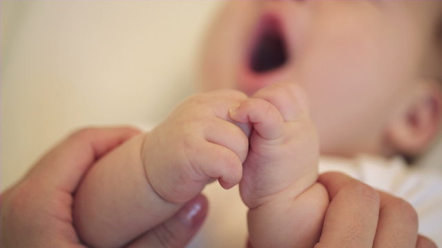 Close Up Parent holding Newborn baby