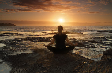Fototapeta na wymiar Meditating or yoga by the sea