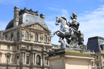 Fototapeta na wymiar Louvre Museum and the Louis XIV Equestrian statue. Paris, France