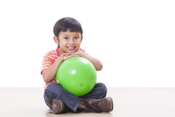 Fototapeta premium Little boy playing green ball 
