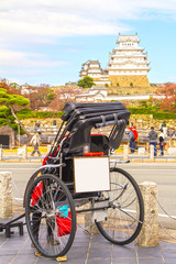 Pulled rickshaw front of Himeji Castle in autumn