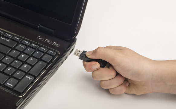 Hand Inserting Usb Memory Stick To Laptop Computer