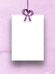 Close-up of one paper sheet frame with pink ribbon on plastic scratched background