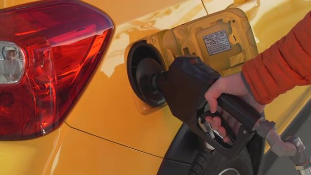 Taxi cab refueling at a gas station