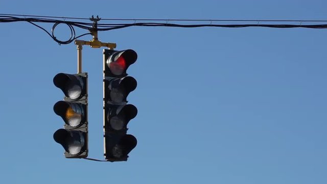 Traffic light hangs over a typical  U.S. roadway.