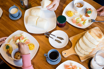 Group of people having breakfast together