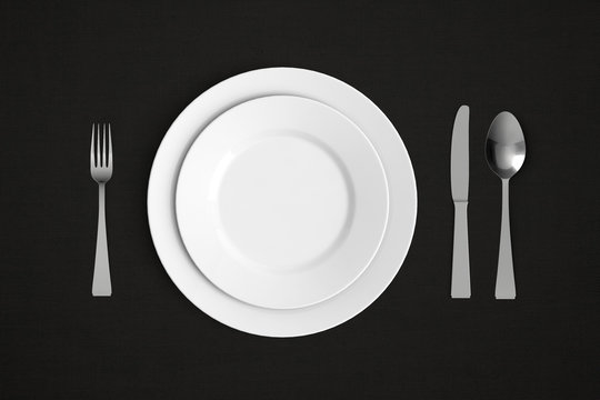 knife, fork and spoon with plates on black tablecloth - banner / backround 