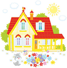 Vector illustration of a country house, a colorful flowerbed and a small grey kitten playing with a butterfly
