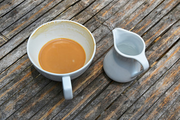 One finished cup of latte coffee on bamboo table