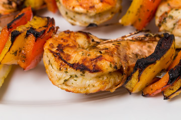 Delicious grilled shrimps on skewers.