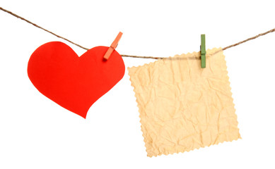 Paper heart and empty sheet hang on cord isolated on white background
