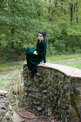 Naklejka na ściany i meble Unusual beautiful bride in a green dress